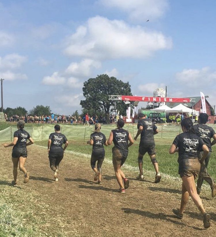 A photo of the Emmi Dental team running in the 2017 Mud Run.
