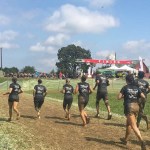 A photo of the Emmi Dental team running in the 2017 Mud Run.